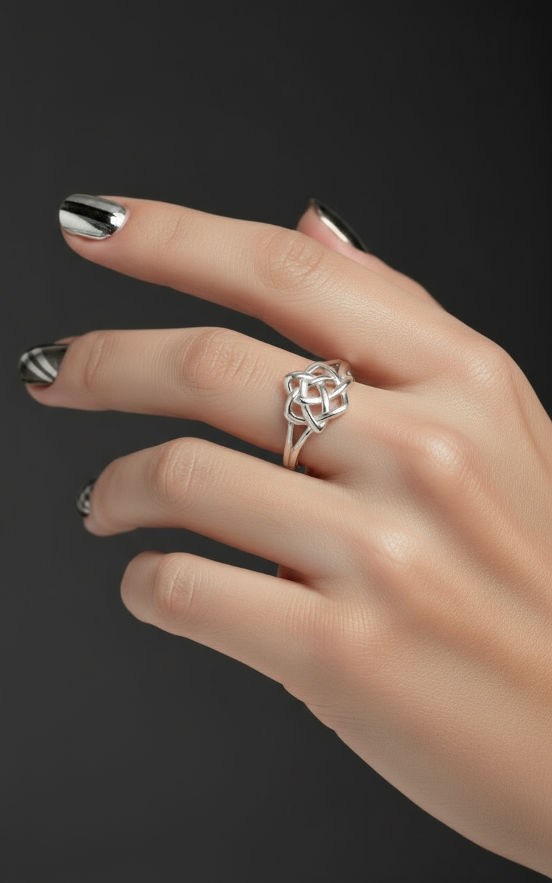 Realistic Celtic knot ring on man's hand with metallic nail art